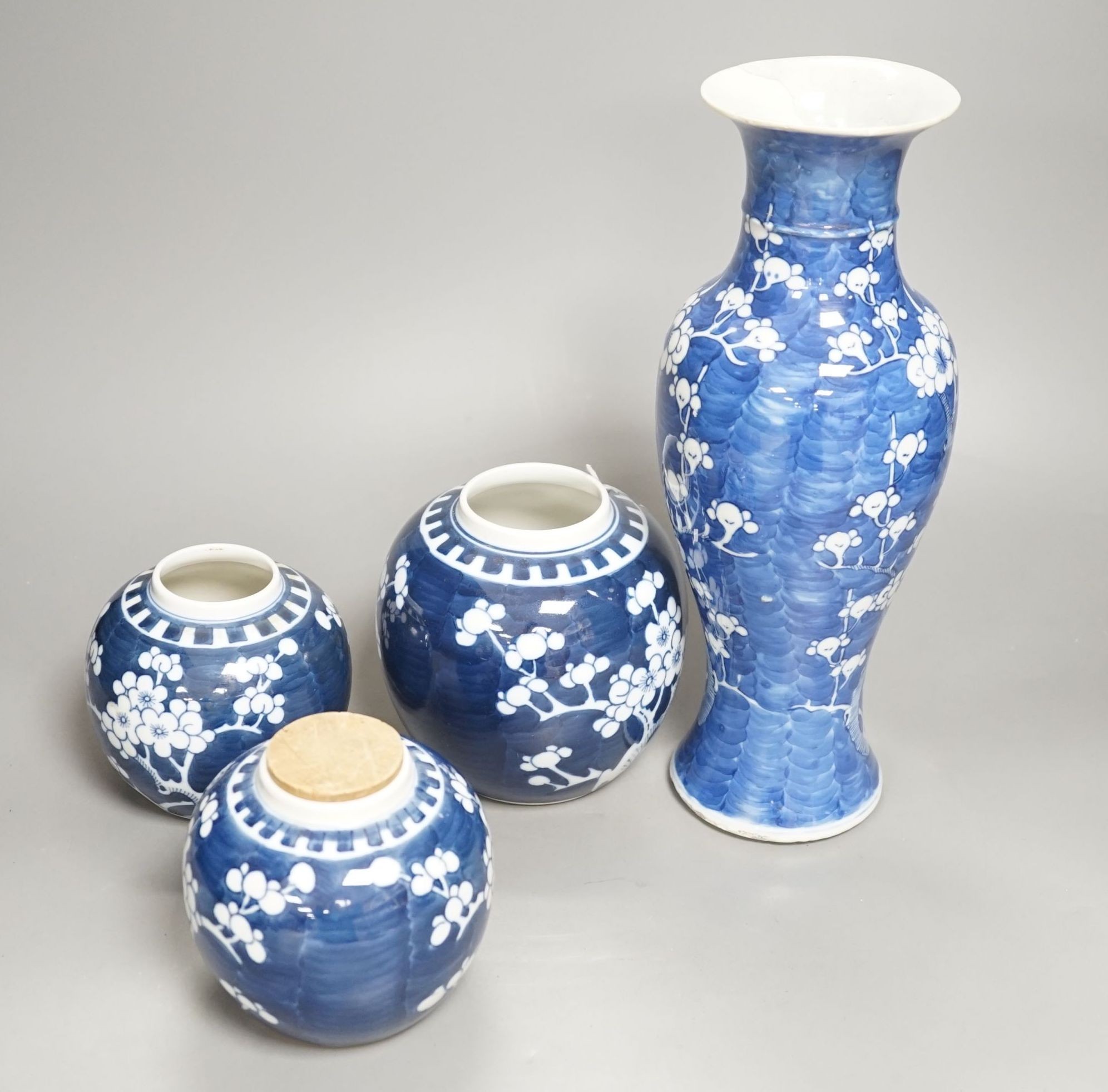 A Chinese blue and white prunus vase together with three similar jars. Vase height 30cm